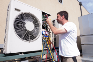 man cleaning and checking an hvac